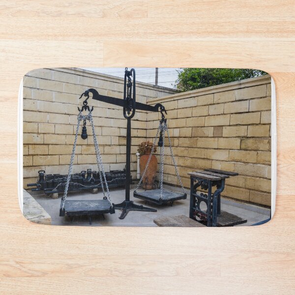 Item preview, Antique Metal Balance Scale With Chains and Platforms in Stone-Walled Courtyard Display designed and sold by Nmallia.