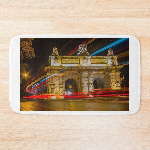 Item preview, Nighttime Long Exposure Of Historic City Arch With Colorful Light Trails And Passing Traffic designed and sold by Nmallia.