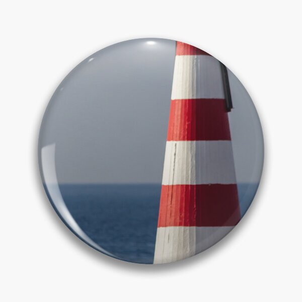Item preview, Red and White Striped Coastal Beacon On Rocky Shore With Calm Blue Sea and Sky designed and sold by Nmallia.