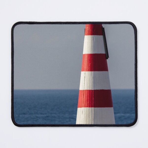 Item preview, Red and White Striped Coastal Beacon On Rocky Shore With Calm Blue Sea and Sky designed and sold by Nmallia.