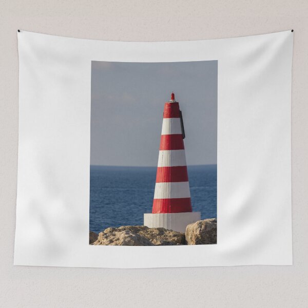 Item preview, Red and White Striped Coastal Beacon On Rocky Shore With Calm Blue Sea and Sky designed and sold by Nmallia.