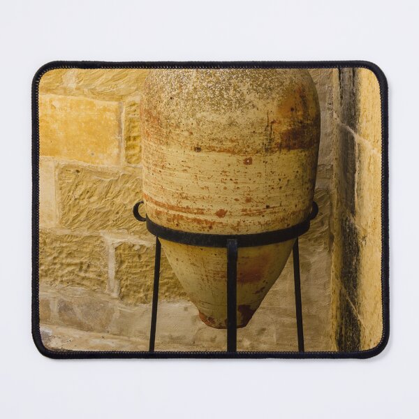 Item preview, Weathered Clay Amphora Pottery Jar On Iron Stand Against Sunlit Limestone Wall In Mediterranean Courtyard designed and sold by Nmallia.