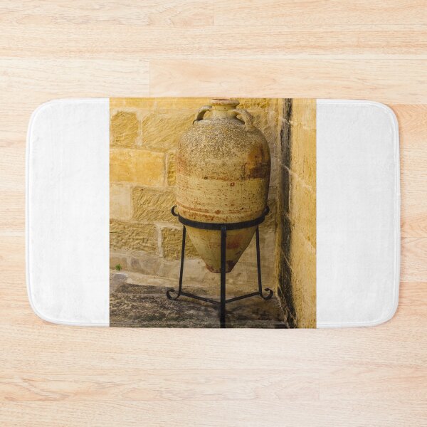 Item preview, Weathered Clay Amphora Pottery Jar On Iron Stand Against Sunlit Limestone Wall In Mediterranean Courtyard designed and sold by Nmallia.
