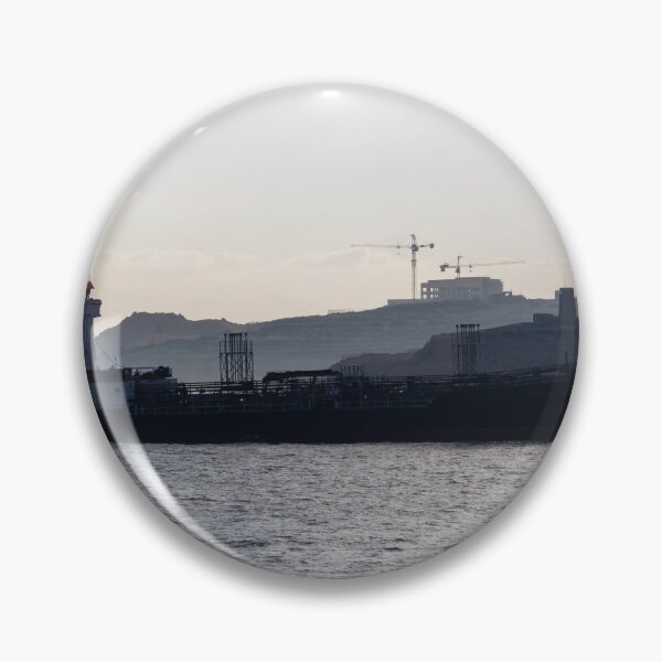 Item preview, Silhouette Cargo Ship and Small Rowboat on Calm Sea Near Coastal Construction at Dusk designed and sold by Nmallia.