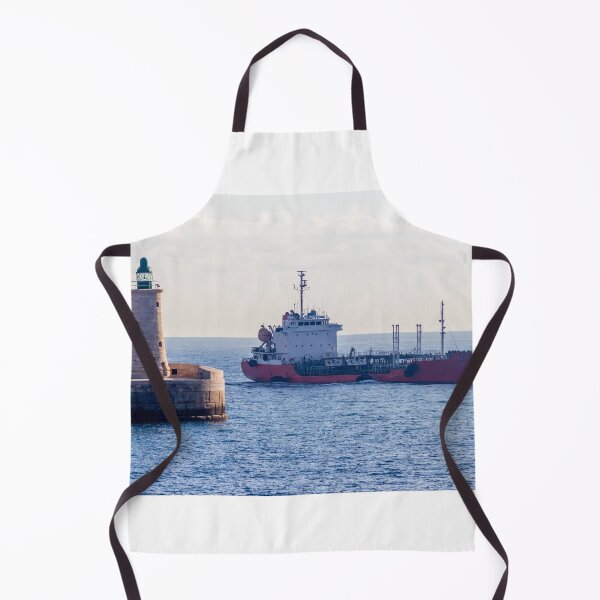 Item preview, Lighthouse Guarding Harbor Entrance as Cargo Ship Passes Along Coastal Waters at Sea designed and sold by Nmallia.