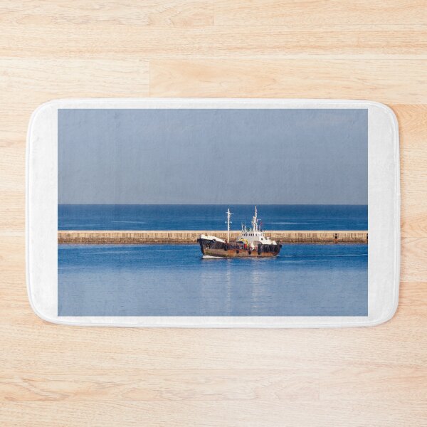 Item preview, Tugboat Departing Harbor Past Breakwater On Calm Blue Sea With Clear Sky Horizon designed and sold by Nmallia.