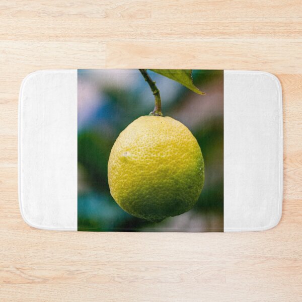Item preview, Close-Up Of Ripe Lemon Hanging From Citrus Tree With Leaf In Garden designed and sold by Nmallia.
