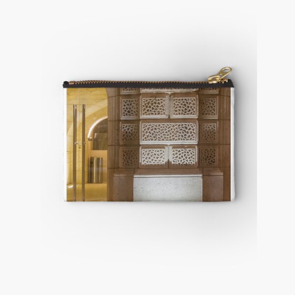 Item preview, Illuminated Historic Stone Wall With Ornate Carved Blocks And Glass Entrance At Night designed and sold by Nmallia.