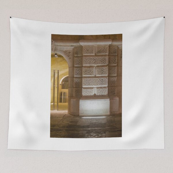Item preview, Illuminated Historic Stone Wall With Ornate Carved Blocks And Glass Entrance At Night designed and sold by Nmallia.