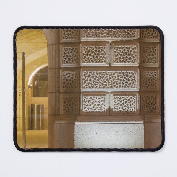 Item preview, Illuminated Historic Stone Wall With Ornate Carved Blocks And Glass Entrance At Night designed and sold by Nmallia.