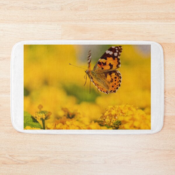 Item preview, Painted Lady Butterfly Hovering Over Bright Yellow Flowers In Sunlit Summer Garden designed and sold by Nmallia.