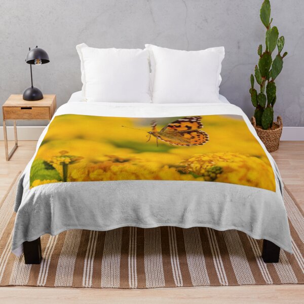 Item preview, Painted Lady Butterfly Hovering Over Bright Yellow Flowers In Sunlit Summer Garden designed and sold by Nmallia.