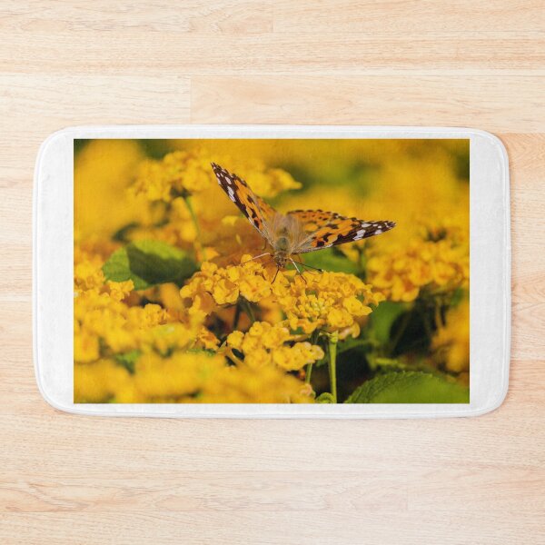 Item preview, Painted Lady Butterfly Hovering Over Bright Yellow Flowers In Sunlit Summer Garden designed and sold by Nmallia.