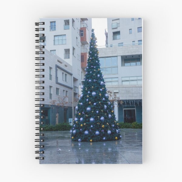Item preview, Decorated Christmas Tree In Urban Plaza With Modern Apartment Buildings And Wet Pavement Reflections designed and sold by Nmallia.