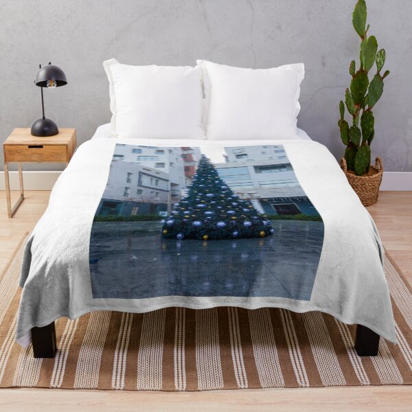 Item preview, Decorated Christmas Tree In Urban Plaza With Modern Apartment Buildings And Wet Pavement Reflections designed and sold by Nmallia.