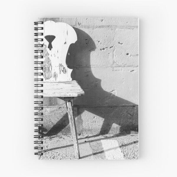 Item preview, Vintage Weathered Wooden Chair Casting Shadow Against Textured Stone Wall in Minimal Black and White designed and sold by Nmallia.