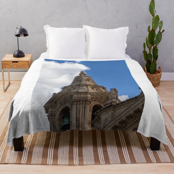 Item preview, Ornate Church Steeple and Bell Tower With Statue Against Blue Sky and Clouds designed and sold by Nmallia.