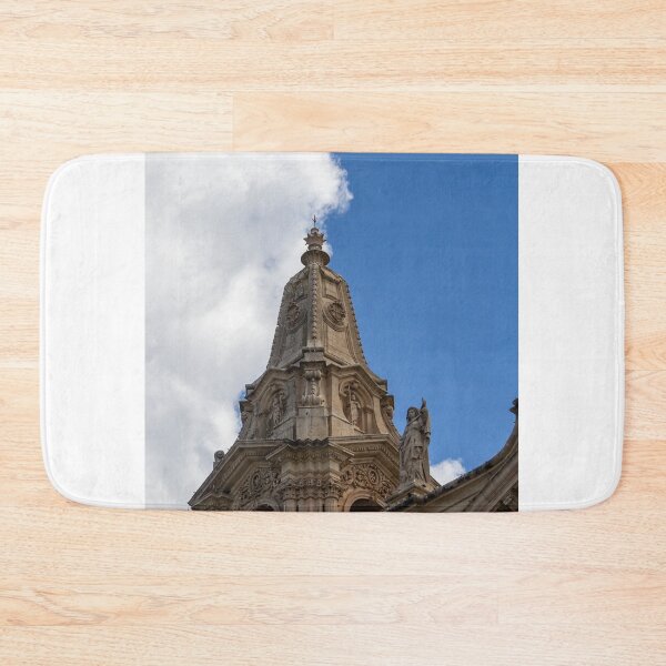 Item preview, Ornate Church Steeple and Bell Tower With Statue Against Blue Sky and Clouds designed and sold by Nmallia.