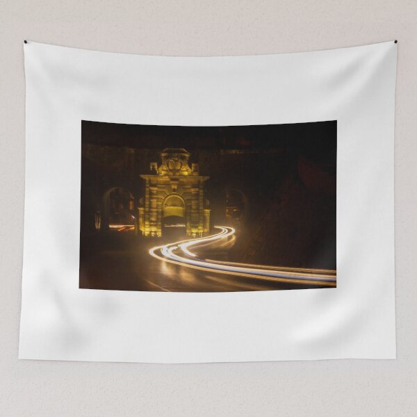 Item preview, Long Exposure Light Trails Curving Past a Historic Stone Gate and Archway at Night designed and sold by Nmallia.