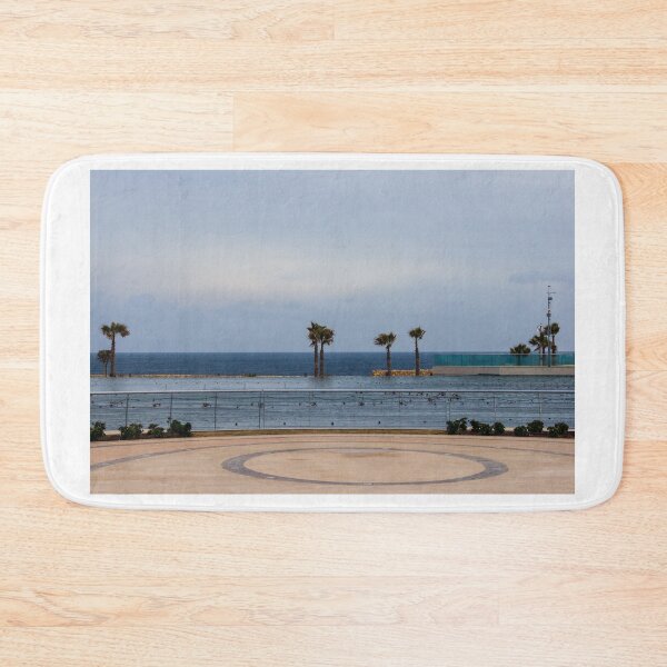 Item preview, Empty Coastal Promenade With Palm Trees Overlooking Ocean and Calm Waterfront on Cloudy Day designed and sold by Nmallia.