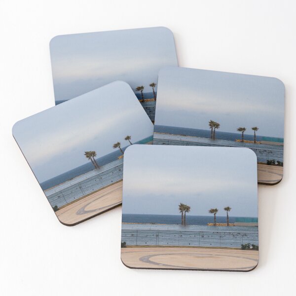 Item preview, Empty Coastal Promenade With Palm Trees Overlooking Ocean and Calm Waterfront on Cloudy Day designed and sold by Nmallia.