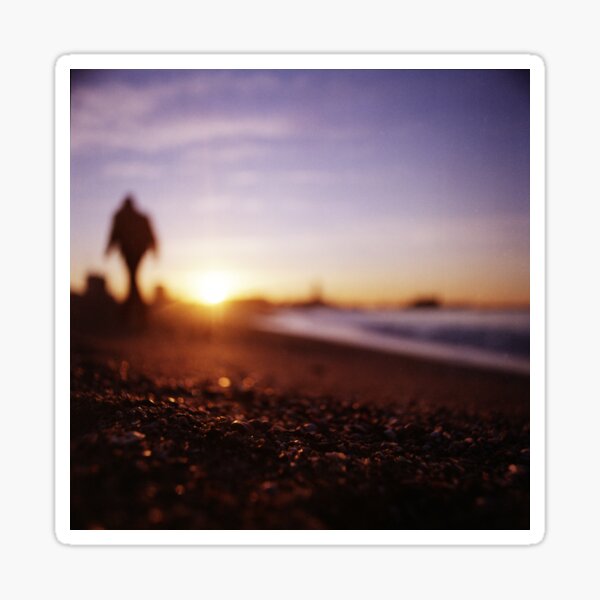 Man walking on beach at sunset square color analogue medium format film Hasselblad photograph Sticker