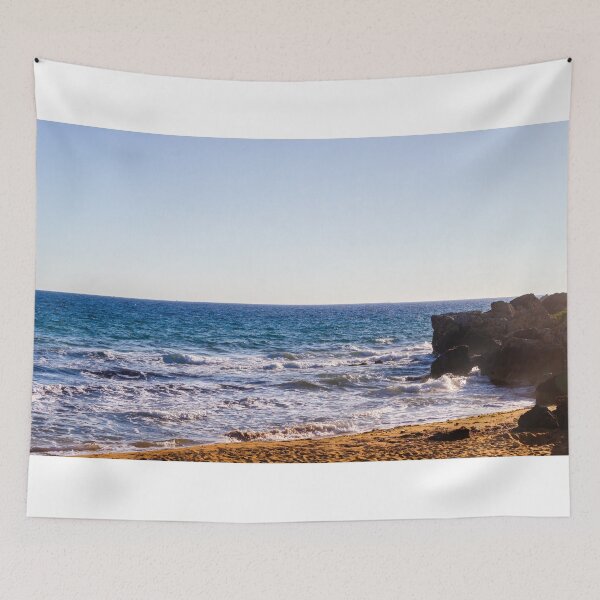 Item preview, Sunlit Rocky Coastline With Waves Crashing On Sandy Beach At Late Afternoon Horizon designed and sold by Nmallia.