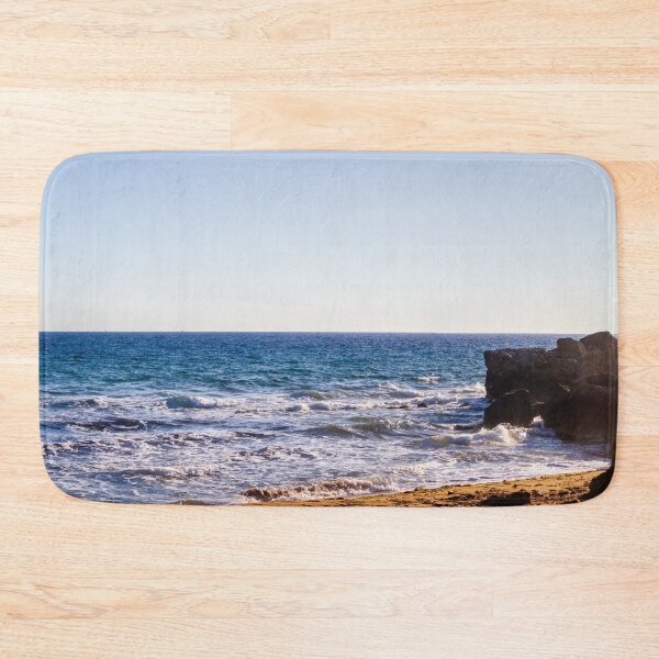 Item preview, Sunlit Rocky Coastline With Waves Crashing On Sandy Beach At Late Afternoon Horizon designed and sold by Nmallia.