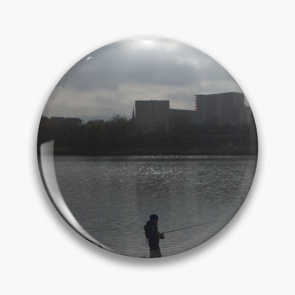 Item preview, Silhouette of a man fishing in a lake near an urban area on a cloudy day. designed and sold by FlorinWorks.