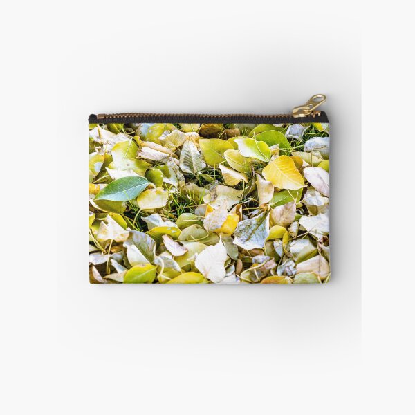 Item preview, Close-up view of fallen autumn leaves in shades of yellow and green covering a grassy ground designed and sold by AbulailArt.
