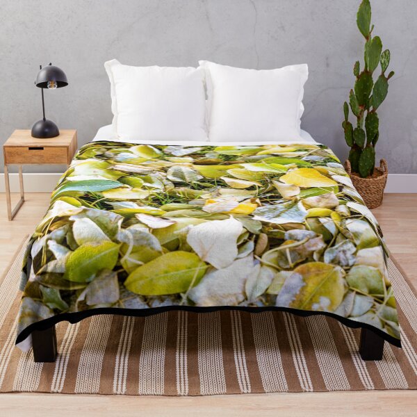 Item preview, Close-up view of fallen autumn leaves in shades of yellow and green covering a grassy ground designed and sold by AbulailArt.