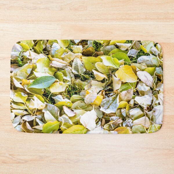 Item preview, Close-up view of fallen autumn leaves in shades of yellow and green covering a grassy ground designed and sold by AbulailArt.