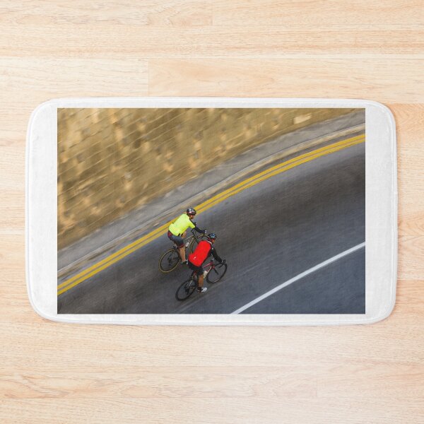 Item preview, Two Road Cyclists Riding Together Along Curved Urban Street in Motion designed and sold by Nmallia.