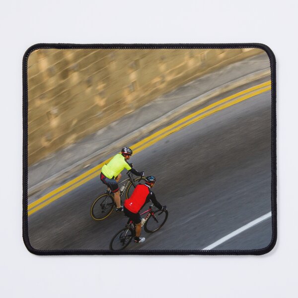 Item preview, Two Road Cyclists Riding Together Along Curved Urban Street in Motion designed and sold by Nmallia.