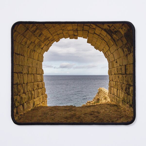 Item preview, Stone Arch Tunnel Framing A Calm Ocean View Over Rocky Coastal Cliff In Golden Light designed and sold by Nmallia.