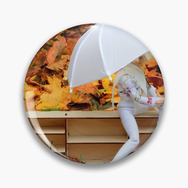 Item preview, Doll with umbrella siting on bookcase with the background of yellow orange autumn leaves designed and sold by Lenasminiland.
