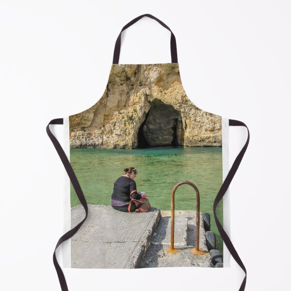 Item preview, Woman Reading On A Pier By Turquoise Water Near A Rocky Sea Cave And Sunlit Cliff designed and sold by Nmallia.