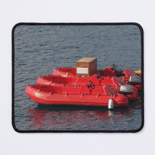 Item preview, Row Of Red Rental Boats Floating On Calm Blue Water Near A Marina For Summer Leisure designed and sold by Nmallia.