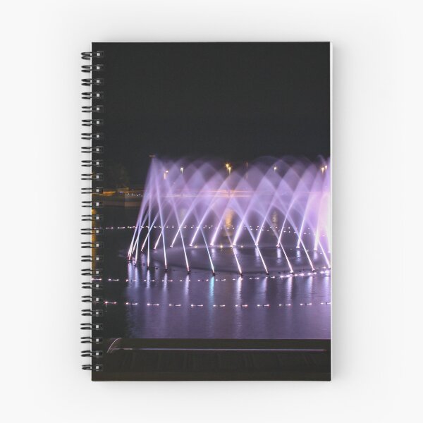 Item preview, Illuminated Circular Fountain Light Show Over Lake at Night With Water Jets and Reflections designed and sold by Nmallia.