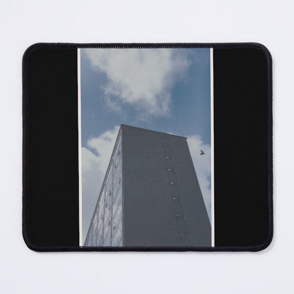 Item preview, bird swoops past a building on a day with a blue sky in glasgow (scotland) (may 2026) designed and sold by photosbykel.