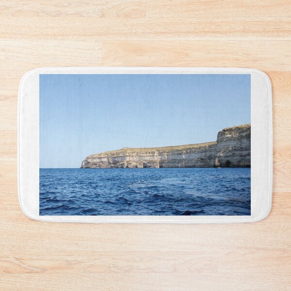 Item preview, Sea Cliffs and Blue Ocean Water Along a Rocky Coastal Landscape Under Clear Sky designed and sold by Nmallia.