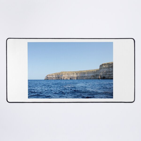 Item preview, Sea Cliffs and Blue Ocean Water Along a Rocky Coastal Landscape Under Clear Sky designed and sold by Nmallia.