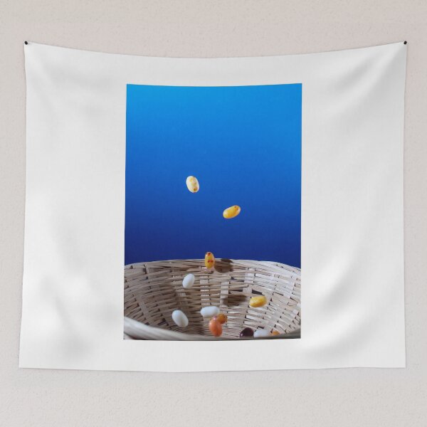 Item preview, Colorful Jellybeans Falling Into A Woven Basket Against A Bright Blue Background designed and sold by Nmallia.