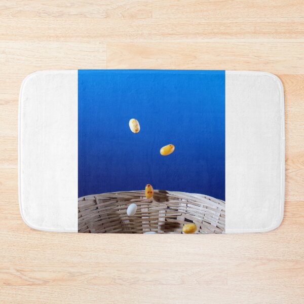 Item preview, Colorful Jellybeans Falling Into A Woven Basket Against A Bright Blue Background designed and sold by Nmallia.