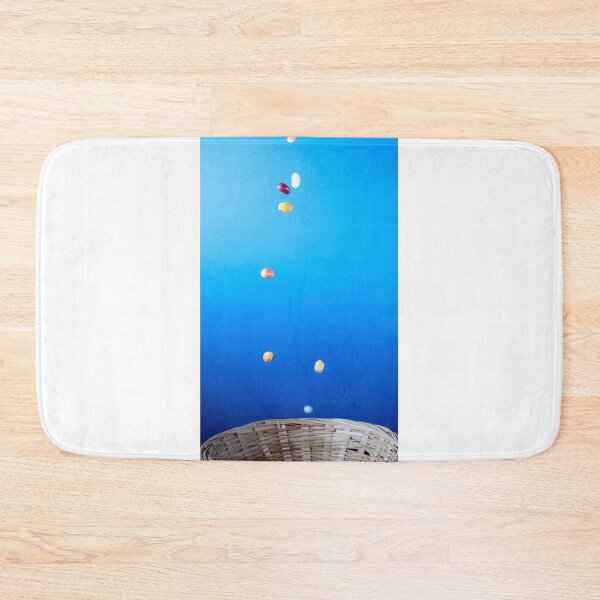 Item preview, Colorful Jellybeans Falling Into A Woven Basket Against A Bright Blue Background designed and sold by Nmallia.
