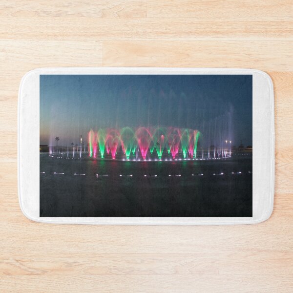 Item preview, Colorful Illuminated Fountain Show At Dusk With Water Jets Over Waterfront designed and sold by Nmallia.