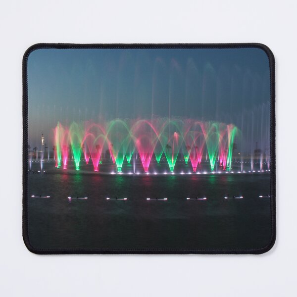 Item preview, Colorful Illuminated Fountain Show At Dusk With Water Jets Over Waterfront designed and sold by Nmallia.