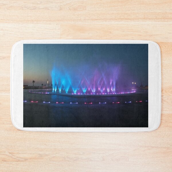 Item preview, Colorful Illuminated Fountain Show At Dusk With Water Jets Over Waterfront designed and sold by Nmallia.