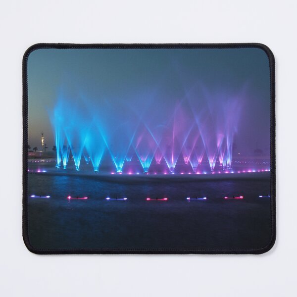 Item preview, Colorful Illuminated Fountain Show At Dusk With Water Jets Over Waterfront designed and sold by Nmallia.