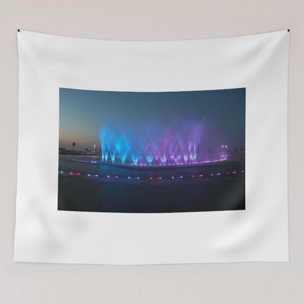 Item preview, Colorful Illuminated Fountain Show At Dusk With Water Jets Over Waterfront designed and sold by Nmallia.